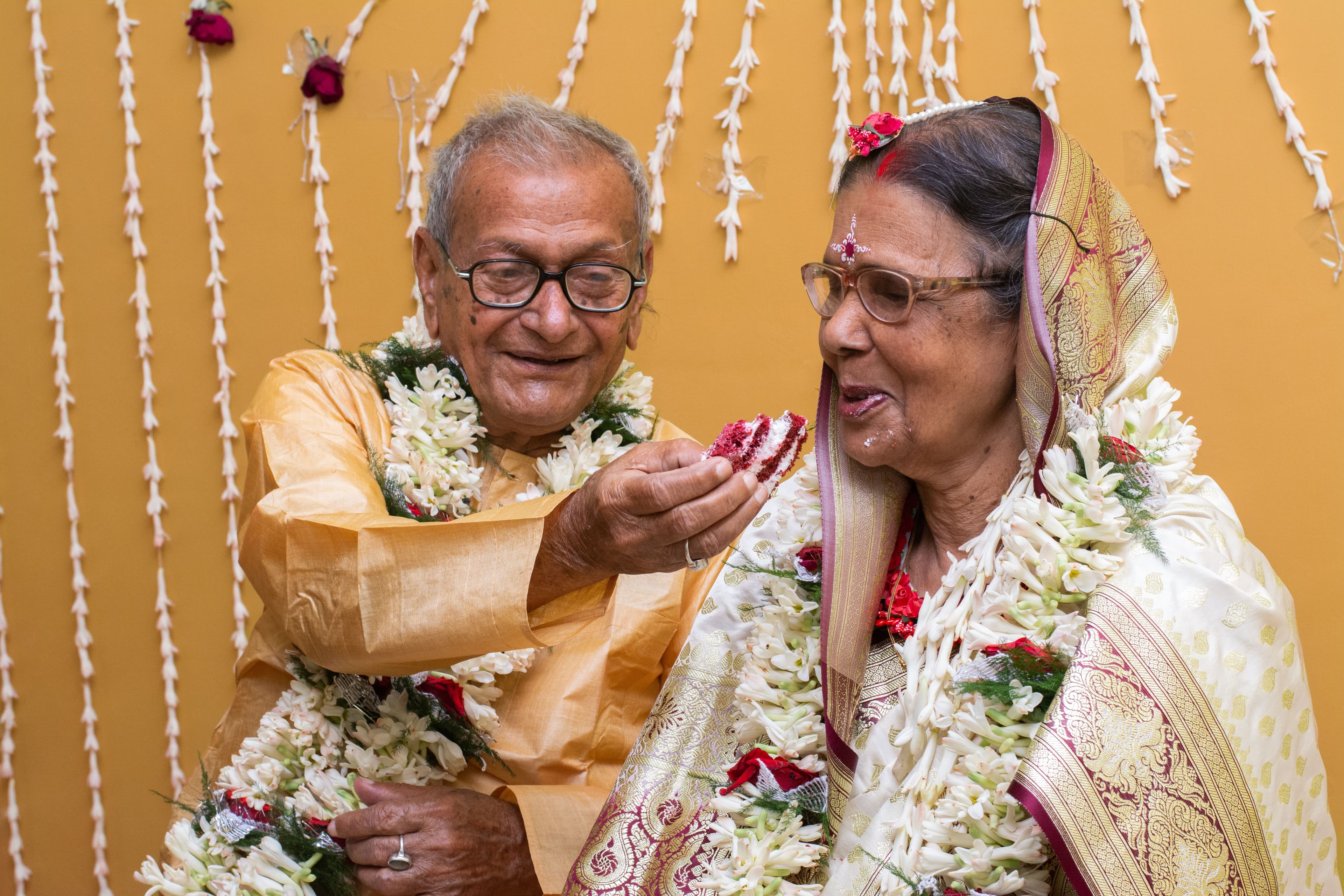 A happy elderly Indian couple celebrating their anniversary together